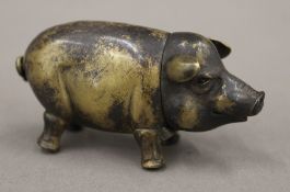 A brass vesta formed as a pig