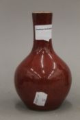 A Chinese porcelain bottle vase, with all over red glaze. 14.