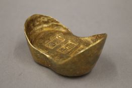 A gold ingot form paperweight