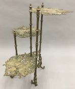 A brass three tier etagere worked with butterflies