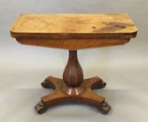 A Victorian mahogany card table, with baluster pedestal and quadripartite plinth base. 91 cm wide.