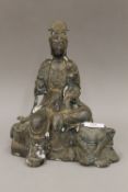 A bronze figure of Guanyin seated on an elephant