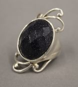 A silver and goldstone ring