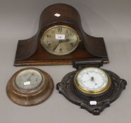 An early 20th century oak mantle clock and two barometers