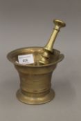 An 18th century bronze pestle and mortar