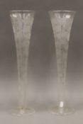 A pair of 19th century large fruiting vine etched clear glass trumpet vases