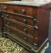 A 19th century mahogany chest of four long drawers with scroll carved brackets,