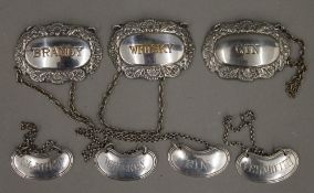 A collection of silver plated decanter labels