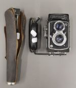 A Yashica-C box camera and tripod