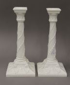 A pair of Royal Worcester porcelain candlesticks