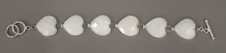 A silver bracelet with inset white heart-shaped links