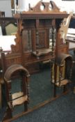 A late Victorian walnut over mantle mirror with integral shelves