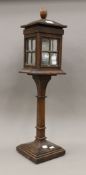 An oak table light modelled as a streetlamp with leaded glazing. 71.5 cm high.