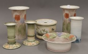 A quantity of Jersey pottery, comprising: a pair of vases, another smaller, a pair of candlesticks,