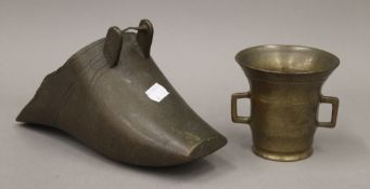 A 17th/18th century European bronze mortar with two lug handles and an antique bronze stirrup