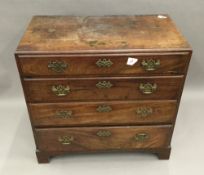 A George III mahogany caddy top chest of four long drawers with crossbanded top,