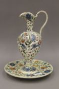 A 19th century Eastern pottery ewer and stand with Iznik decoration