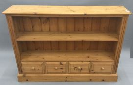 A modern pine bookcase with drawers below