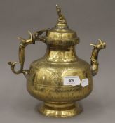 A 19th century Indian brass ewer with Indian Hindu finial