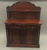 A Victorian mahogany chiffonier with shelf back and panelled cupboard doors