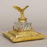 A 19th century brass mounted cut and moulded glass inkwell The hinged cover surmounted with an