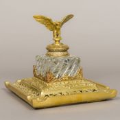 A 19th century brass mounted cut and moulded glass inkwell The hinged cover surmounted with an