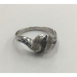 An 18 ct white gold diamond and sapphire ring Of swirling banded form. 8 cm high.