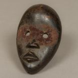 A small African carved wooden tribal mask,