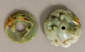 Two Chinese carved jade roundels Both worked with mythical beasts. The larger 7 cm diameter.