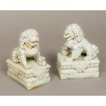 A pair of Chinese porcelain dogs-of-fo Each typically modelled in allover blue/white glaze.