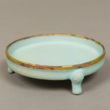 A Chinese porcelain censer Of shallow circular form with allover blue glaze with a gilt rim.