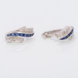 A pair of 18 ct white gold, diamond and sapphire earrings Each of swirling banded form. Each 1.