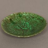 A Chinese Tang Dynasty pottery slip decorated peacock feather dish With green glaze. 13.
