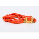 A coral bead four strand bracelet Set with gold clasp. Approximately 20 cm long.