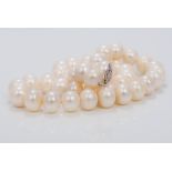 A pearl bead necklace Set with a pierced 14K white gold clasp. 42.5 cm long.