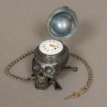 A French memento mori silver cased desk timepiece modelled as a skull The hinged cranium revealing