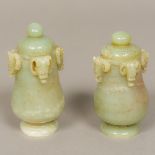 A near pair of Chinese carved jade lidded vases Each decorated with mythical beast masks.