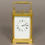 A 19th century French brass cased repeating carriage clock by Armand Couaillet The white enamelled