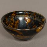 A Chinese Song Dynasty pottery bowl With allover treacle glaze. 12 cm diameter.