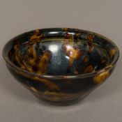 A Chinese Song Dynasty pottery bowl With allover treacle glaze. 12 cm diameter.