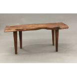 A Reynolds of Ludlow yewwood coffee table The naturalistic plank top supported on tapering legs,