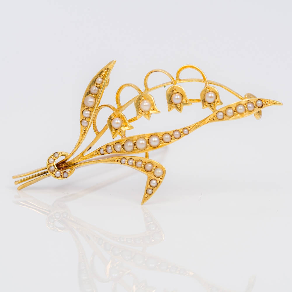 An 18 ct gold seed pearl set brooch Formed as a lily-of-the-valley spray. 5 cm long.