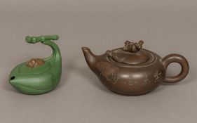 Two Chinese Yixing pottery teapots One worked with a boy riding a water buffalo,
