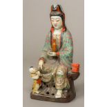 A Chinese porcelain figural group formed as Guanyin Modelled seated holding a vase and a young