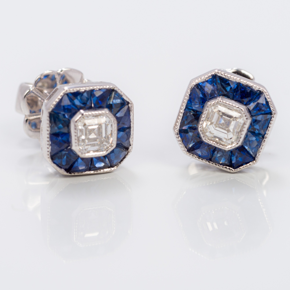 A pair of Art Deco style 18 ct white gold square set diamond and sapphire earrings Each of canted