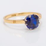 An antique 18 ct gold and sapphire solitaire ring The claw set sapphire spreading to just under 2