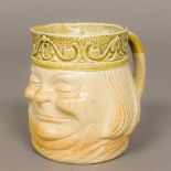 An unusual Victorian Doulton Lambeth stoneware character mug Modelled grinning with upturned collar,