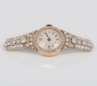 A 14 ct gold cased diamond encrusted lady's cocktail watch The dial 1.5 cm.