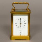 A brass cased carriage alarm clock,