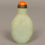 A Chinese carved jade snuff bottle and stopper Decorated with concentric circles. 8.5 cm high.